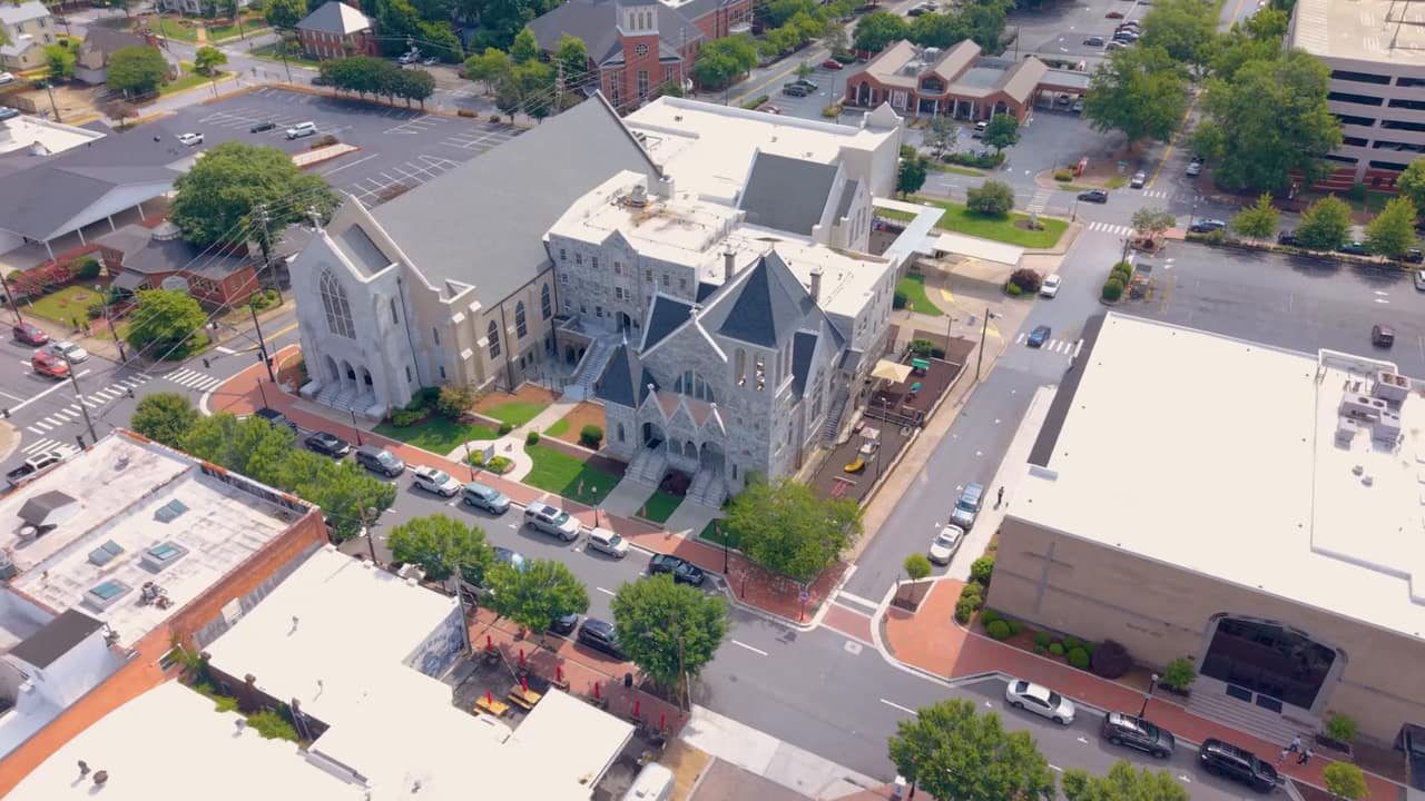 Aerial view of a church and the streets and buildings around a town square