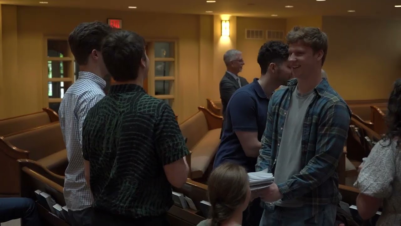 People talking together between the pews at Incarnation Anglican Church