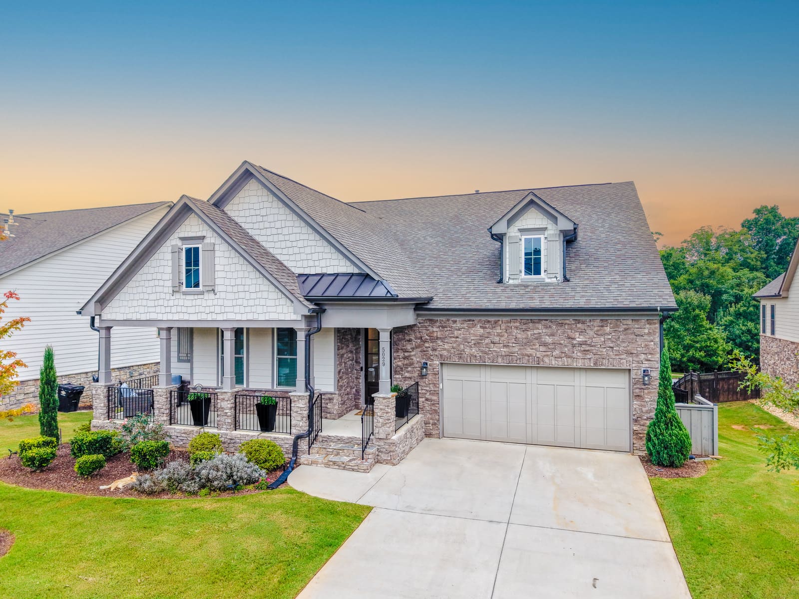 Front elevation of the Rathwood Circle home with its covered porch and two car garage